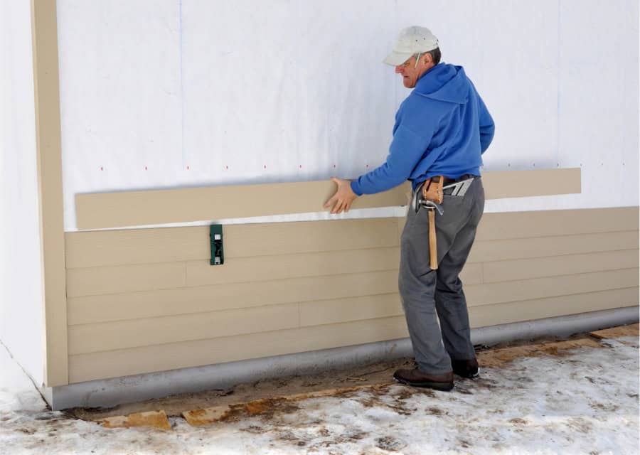 contractor installing siding